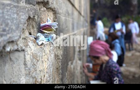 Slips of paper containing prayers wedged into the cracks of the Western Wall outside the Tomb of the Patriarchs, known to Jews by its Biblical name Cave of Machpelah and to Muslims as al-Haram al-Ibrahimi, a site that is believed to be the final resting place of the prophet Abraham a holy figure for Jews and Muslims, located in the heart of the old city in Hebron, Israel. Stock Photo