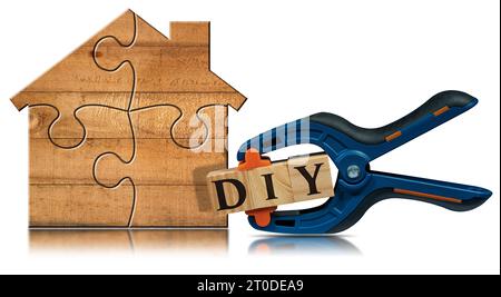 Wooden house made of puzzle pieces and a spring plastic clamp and text Diy (do it yourself), made of wooden blocks, isolated on white background. Stock Photo