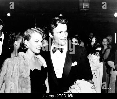 Miss Vermont 1953, Miss USA 1955 and Model CARLENE KING JOHNSON and BARRY COE at the New York premiere in April 1956 of GREGORY PECK JENNIFER JONES and FREDRIC MARCH in THE MAN IN THE GRAY FLANNEL SUIT 1956 director / screenplay NUNNALLY JOHNSON novel Sloan Wilson music Bernard Herrmann producer Darryl F. Zanuck Twentieth Century Fox Stock Photo