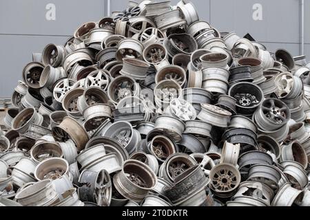 Scrapyard Closeup: Aluminum Rims for Recycling. Pile of old car rims at ...