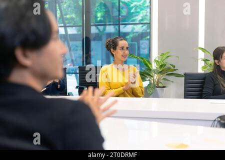 Business meeting with a successful moment. A group of diversity business people colleagues applause, clapping hands and hand closed fist show up for h Stock Photo