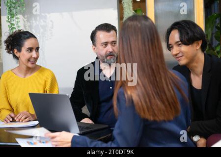 Group of diverse employees business people team during brainstorming. They are discussing new ideas for the new project. Multiracial coworkers working Stock Photo