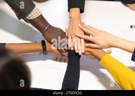 Business people putting hands together. Group of diversity team members expressing a cooperation teamwork moment. Stock Photo