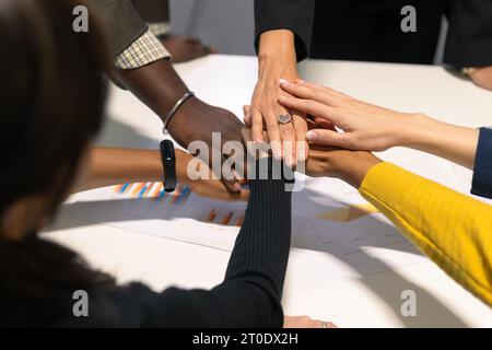 Business people putting hands together. Group of diversity team members expressing a cooperation teamwork moment. Stock Photo