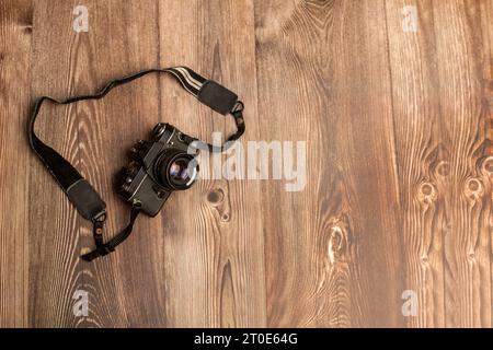 Old film analogue SLR on wooden background Stock Photo