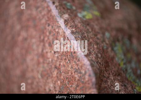 Granite moss-covered stone, cut in half, polished. Stock Photo