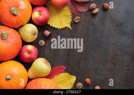 Autumn background with pumpkins, apples, fallen leaves on the dark ...