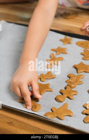 child in the kitchen makes homemade cookies. kid cook at home Stock Photo