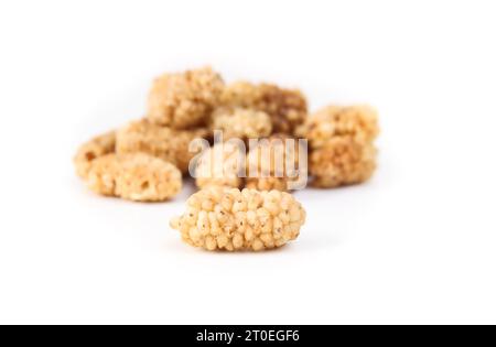 Dried mulberries in a pile, isolated. Dehydrated organic fruit used as snack, granola or in baking. Superfood. Selective focus with defocused pile of Stock Photo