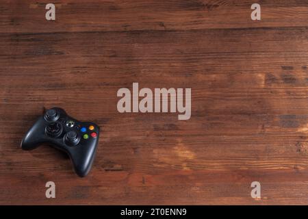 An isolated gaming controller rests on a table, with no other items present Stock Photo