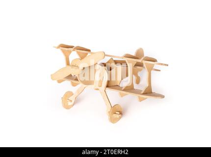 Isolated model wood plane. Wooden vintage double-decker plane or oldtimer airplane. Made of wood sections. Aviation or history of aircraft concept. Se Stock Photo