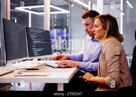 Computer Programmer Writing Program Code On Computer In Office Stock Photo