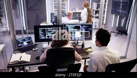 Computer Programmer Writing Program Code On Computer In Office Stock Photo