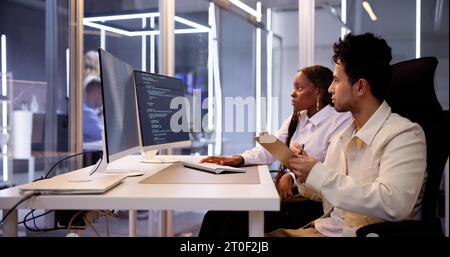 Computer Programmer Writing Program Code On Computer In Office Stock Photo