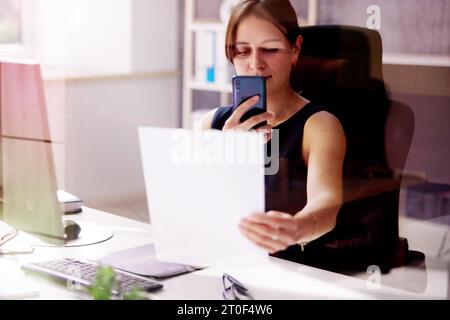 Taking Document Picture Or Photo With Phone. Smartphone Optical Document Stock Photo