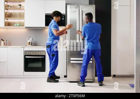 Electrician Technician Working To Repair Refrigerator Or Fridge Appliance Stock Photo