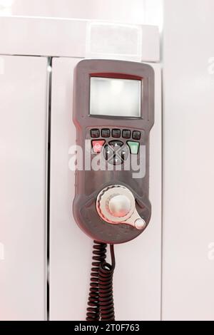 Wired Machine Remote Control With Display and Precise Jog Dial in Factory Stock Photo
