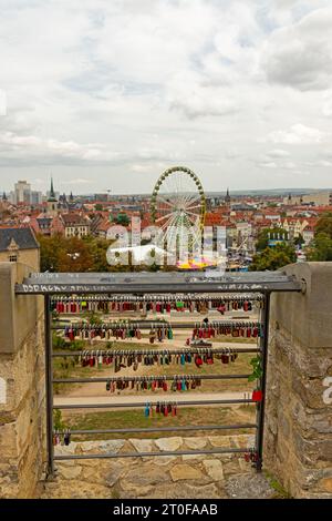 love locks at the Petersberg hill in Erfurt with view over the cathedral square in the background Stock Photo