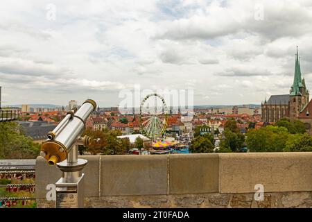 view from the Petersberg in Erfurt over  the cathedral square during Oktoberfest with a telescope in the foreground Stock Photo