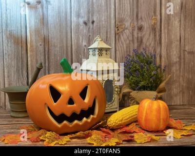Halloween pumpkin head lantern with candles an pumpkin on wooden background Stock Photo
