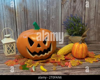 Halloween pumpkin head lantern with candles an pumpkin on wooden background Stock Photo