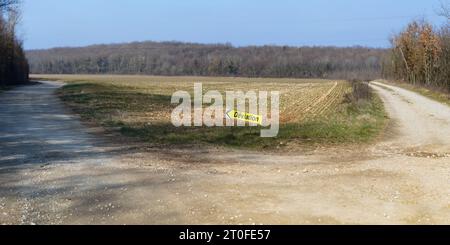 Diversion sign on the forest gravel road in a France shows to left. Stock Photo