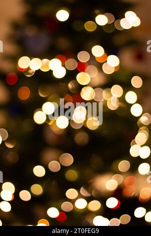 Golden Christmas lights, unfocused. Illuminated bokeh background. Glowing lights, defocused. Winter holidays magic. Golden stardust lights. Stock Photo