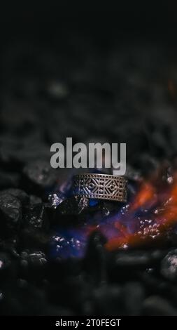 viking style silver ring, product photo with silver ring, ring forged in flames Stock Photo
