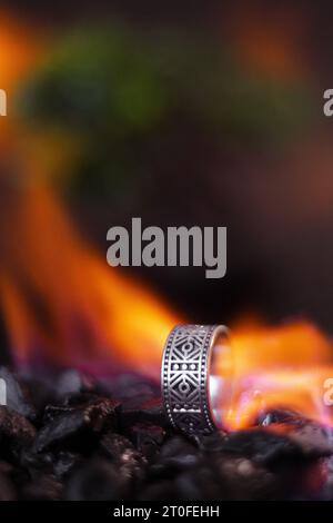 viking style silver ring, product photo with silver ring, ring forged in flames Stock Photo