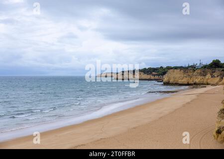Beautiful empty beach of Praia de Armacao de Pera on a cloud day. Silves in Algarve, Portugal Stock Photo