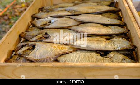 Smoked fish in a craft paper box. Ready for product delivery. Baltic Sea fish. Smoked fish production concept. Stock Photo