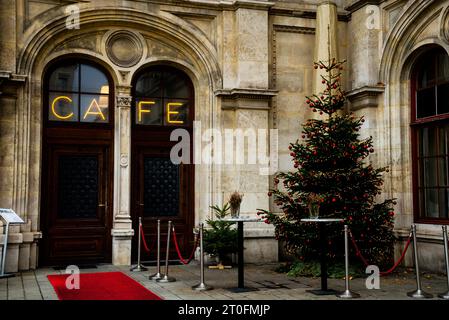 Cafe and Christmas tree in a quiet corner of the Neo-Renaissance Vienna State Opera House in Austria. Stock Photo