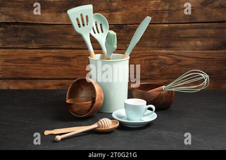 Set of different kitchen utensils on grey table Stock Photo