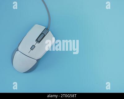 Computer wired gaming mouse white Isolated on a blue background Stock Photo