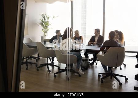 Diverse team of business partners discussing deal in modern office Stock Photo