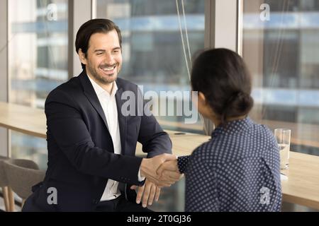 Positive confident business leader man giving handshake to colleague Stock Photo