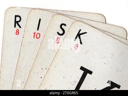 Vintage Lexicon playing cards spelling the word RISK on a white background. Stock Photo