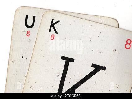 Vintage Lexicon playing cards spelling the word UK on a white background. Stock Photo