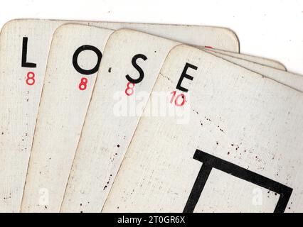 Vintage Lexicon playing cards spelling the word LOSE on a white background. Stock Photo