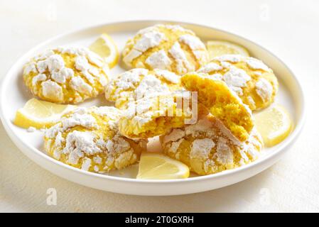 Homemade lemon crinkle cookies on plate over light background. Close up view Stock Photo