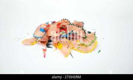 Green pencils and shavings on a white background with colorful pencil shavings. Whole and broken lead pencils on white background. The rest of the pen Stock Photo
