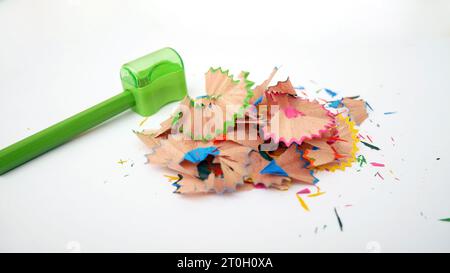 Green pencils and shavings on a white background with colorful pencil shavings. Whole and broken lead pencils on white background. The rest of the pen Stock Photo