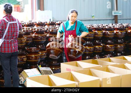 CHONGQING, CHINA - OCTOBER 7, 2023 - A worker boxes kimchi containers in a workshop in Chongqing, China, October 7, 2023. Stock Photo