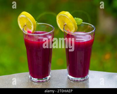 Freshly squeezed juice of beetroot with apple and lemon in a juice glass Stock Photo