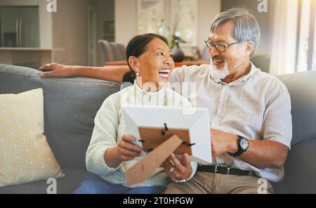 Picture frame, happy and senior couple on a sofa bonding, talking and relaxing together in living room. Smile, laugh and elderly man and woman in Stock Photo