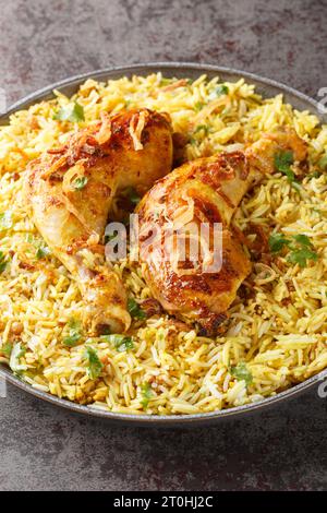 Perfect Bangladeshi Chicken Roast with fried onion and garnish with pulao closeup on the plate on the table. Vertical Stock Photo