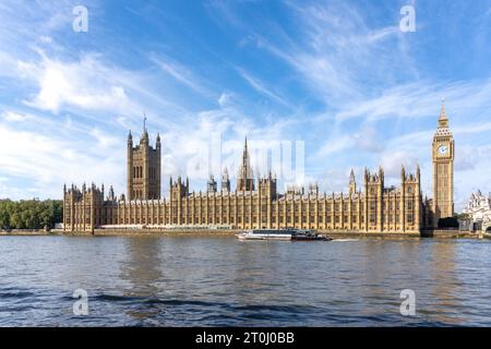 Uber cruise boat passing Houses of Parliament on River Thames, South Bank, London Borough of Lambeth, Greater London, England, United Kingdom Stock Photo