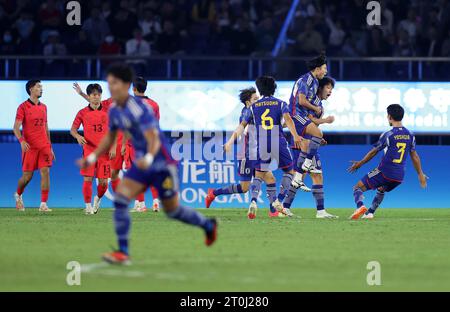 Hangzhou, China's Zhejiang Province. 7th Oct, 2023. Players (blue) of Japan celebrate scoring during the Men's Gold Medal Match of Football between South Korea and Japan at the 19th Asian Games in Hangzhou, east China's Zhejiang Province, Oct. 7, 2023. Credit: Jia Haocheng/Xinhua/Alamy Live News Stock Photo