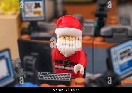 Tambov, Russian Federation - September 30, 2023 A Lego Santa Claus minifigure working on a computer in his office. Close up. Stock Photo
