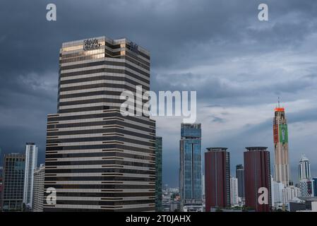 Bangkok, Thailand - September 16, 2023: Siam Piwat Tower and other skyscrapers of the downtown against the evening cloudy sky. Stock Photo